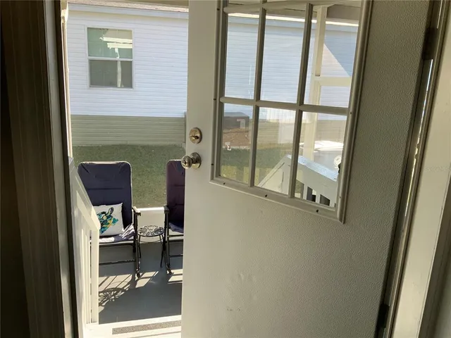a view of a balcony with chair and door