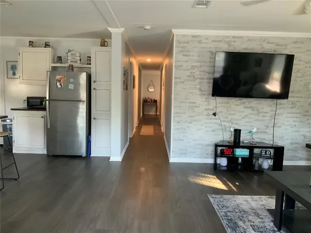 a living room with furniture wooden floor and a flat screen tv
