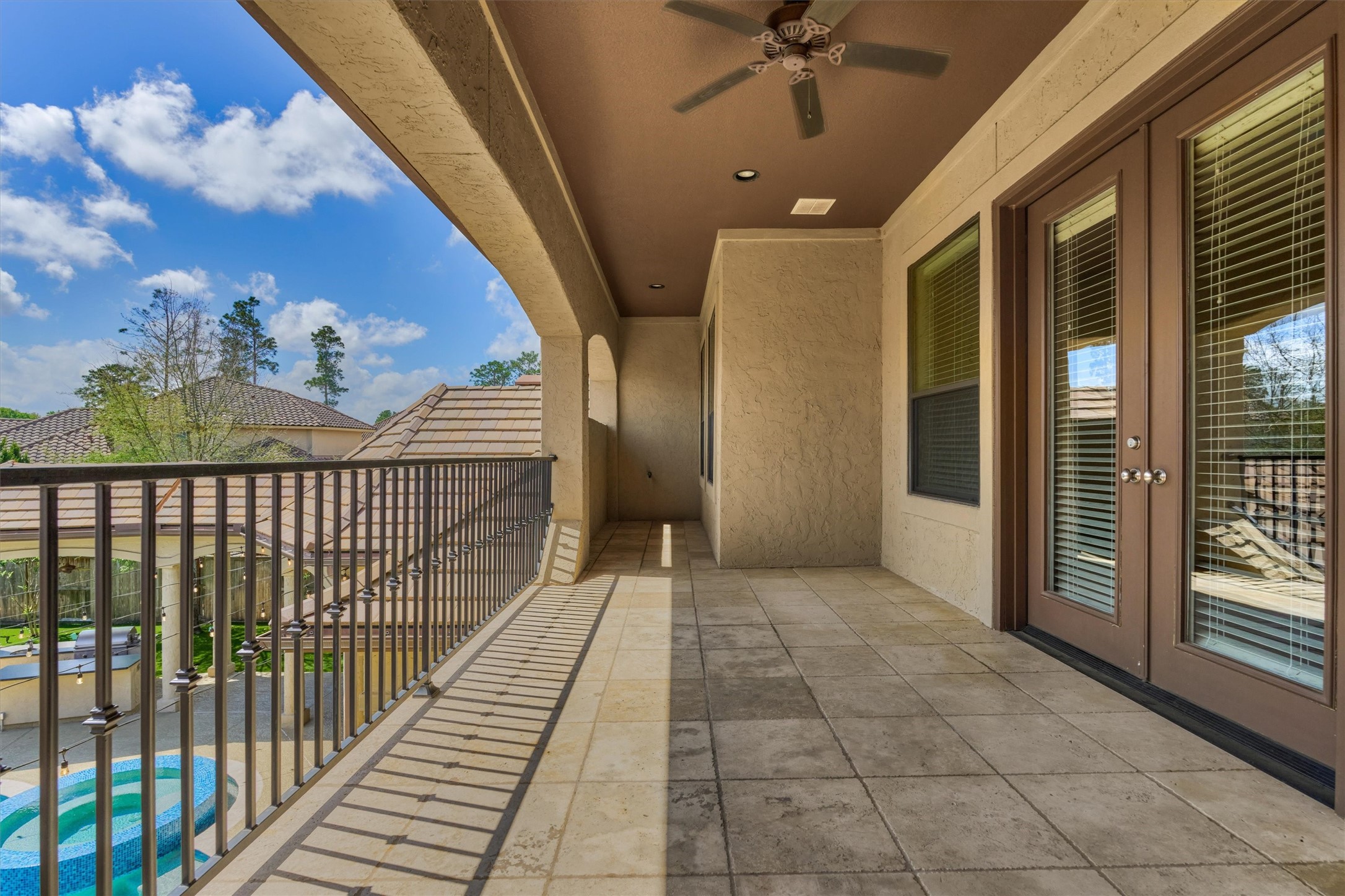 25 Post Shadow Estate Drive Spring, TX 77389 - Photo 42 of 49 Covered balcony with tile flooring, ceiling fan, and French doors overlooking the backyard.