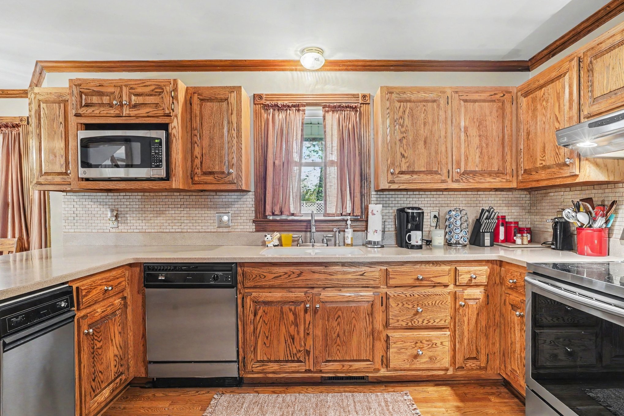2075 Liebengood Road Goodlettsville, TN 37072 - Photo 11 of 40 a kitchen with stainless steel appliances granite countertop a stove a sink and a microwave