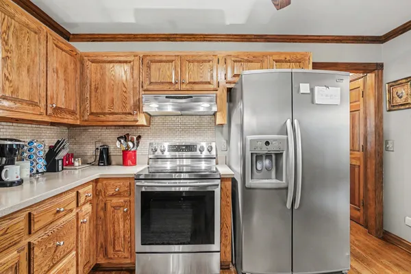 a kitchen with stainless steel appliances granite countertop a refrigerator and a stove