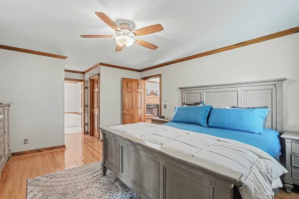 a bedroom with a large bed and a chandelier