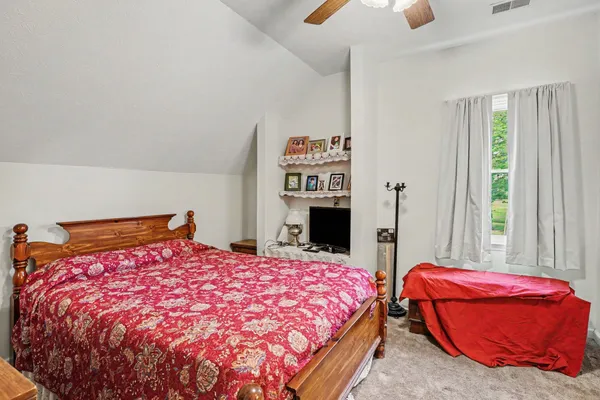 a bedroom with a bed and a couch