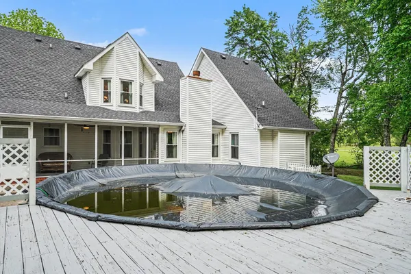 a view of a house with a yard and potted plants