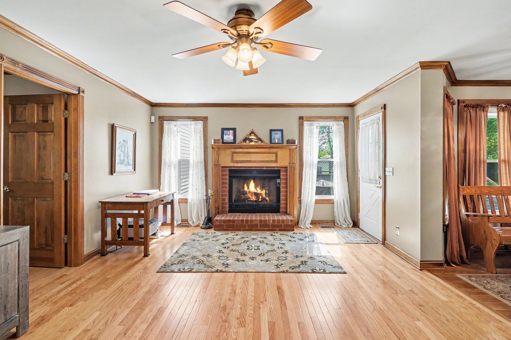 2075 Liebengood Road Goodlettsville, TN 37072 - Photo 6 of 40 a view of a livingroom with a fireplace a chandelier and wooden floor
