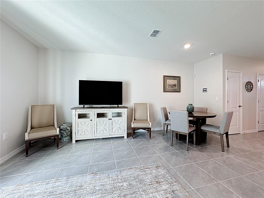 3140 Goose Road Davenport, FL 33837 - Photo 13 of 40 a living room with furniture and a flat screen tv