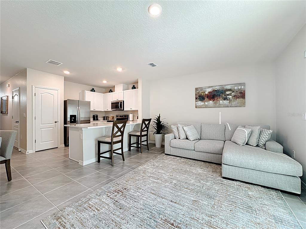 3140 Goose Road Davenport, FL 33837 - Photo 15 of 40 a living room with furniture and kitchen view