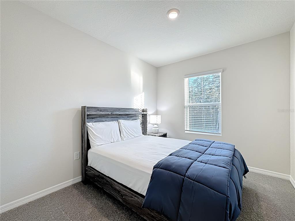 3140 Goose Road Davenport, FL 33837 - Photo 17 of 40 a bedroom with a bed and a window