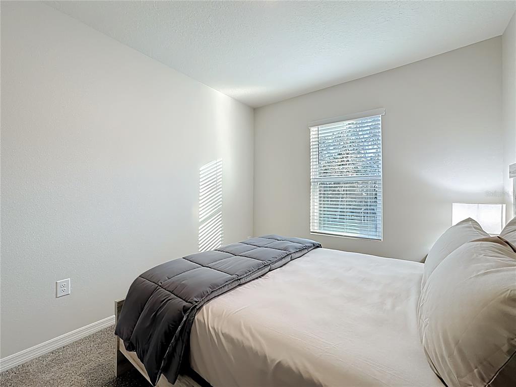 3140 Goose Road Davenport, FL 33837 - Photo 19 of 40 a bedroom with a bed and a window