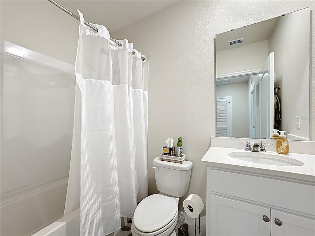 3140 Goose Road Davenport, FL 33837 - Photo 22 of 40 a bathroom with a sink toilet and shower