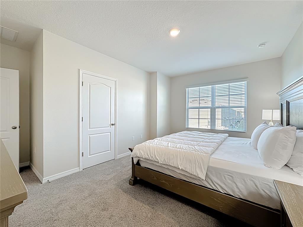 3140 Goose Road Davenport, FL 33837 - Photo 23 of 40 a bedroom with a bed and a window