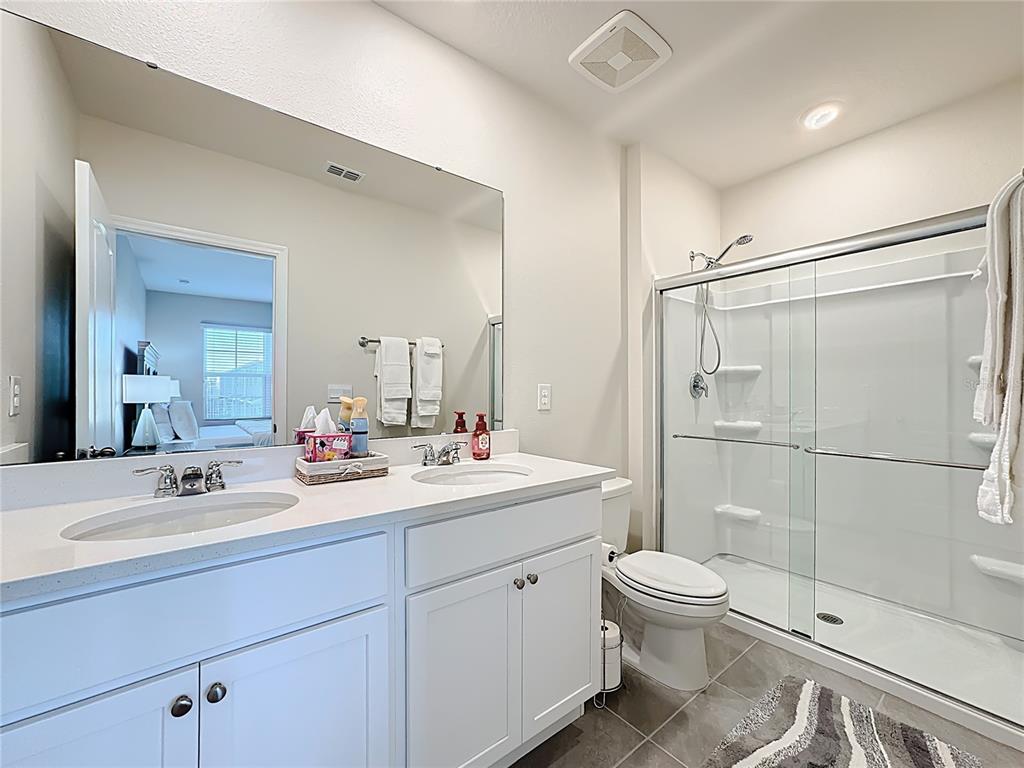 3140 Goose Road Davenport, FL 33837 - Photo 26 of 40 a bathroom with a sink toilet and shower