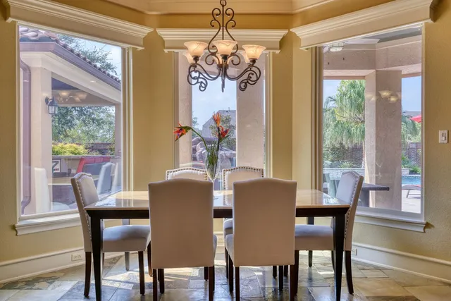 a living room with furniture fireplace and a large window