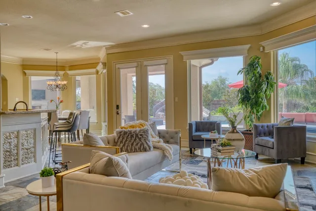 a kitchen with stainless steel appliances granite countertop a sink a stove and a wooden floors