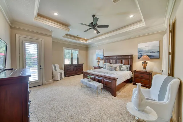 a living room with furniture a flat screen tv and a table