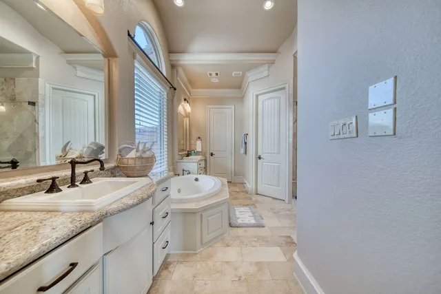 a spacious bedroom with a bed and a dresser in it