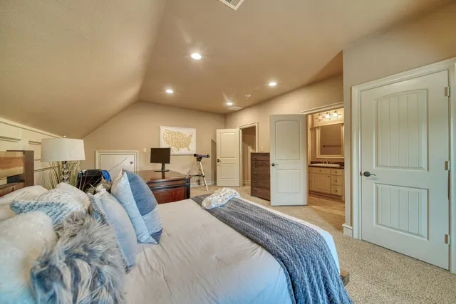 a bathroom with a sink a toilet a window and shower