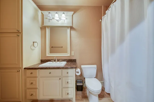 an aerial view of a house with a yard and garden