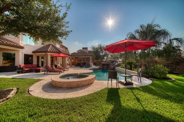 a outdoor space with patio the couches and a fireplace