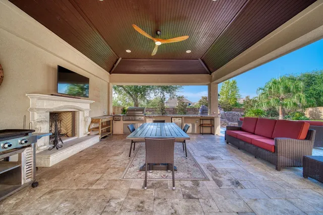 a dining room with furniture a chandelier and wooden floor