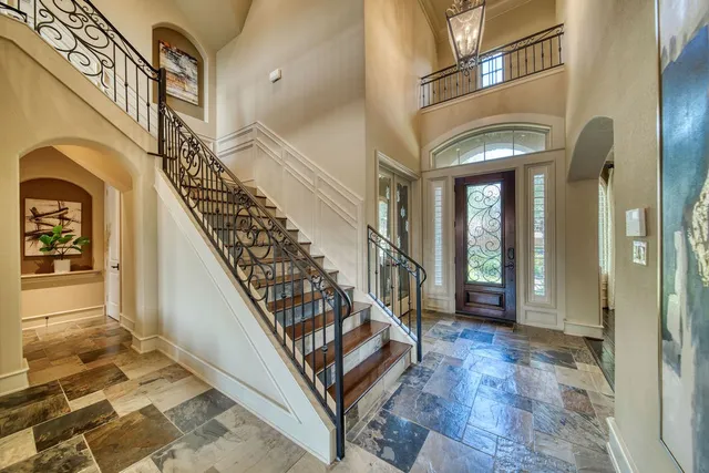 a view of a dining room with furniture and a chandelier