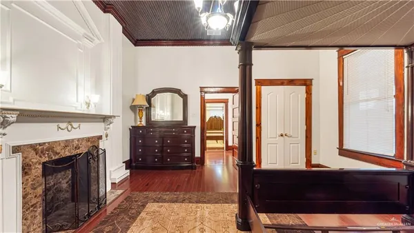 a living room with furniture a flat screen tv and a floor to ceiling window