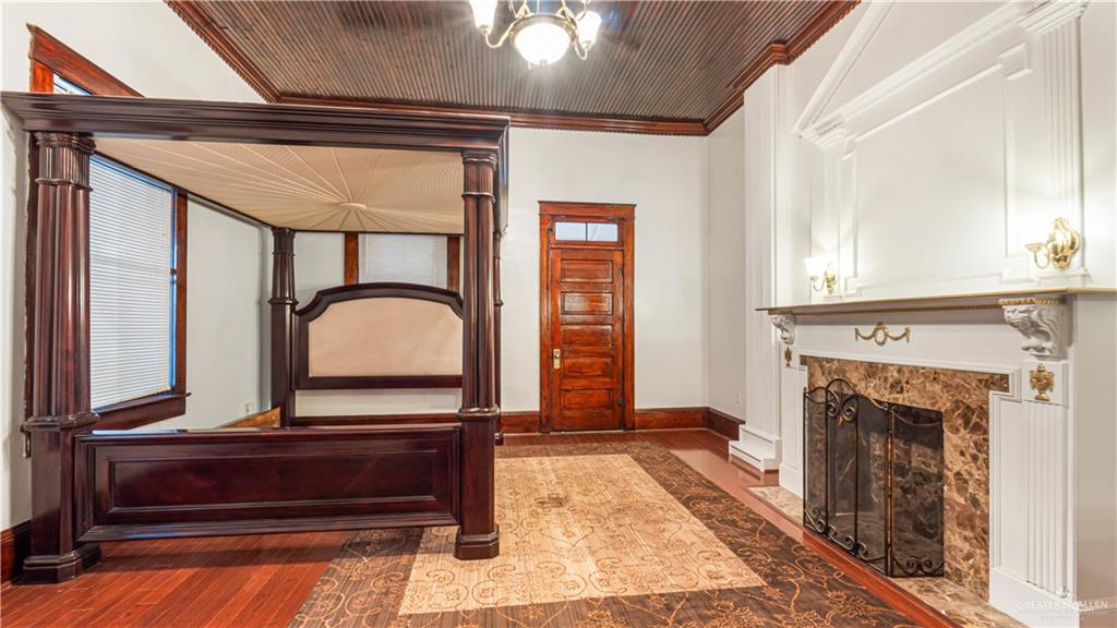 600 East Mirasoles Street Rio Grande City, TX 78582 - Photo 15 of 26 a living room with a fireplace windows and a wooden floor