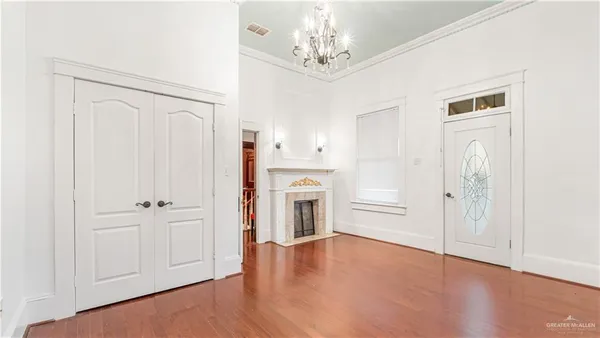 a living room with hardwood floor and hallway