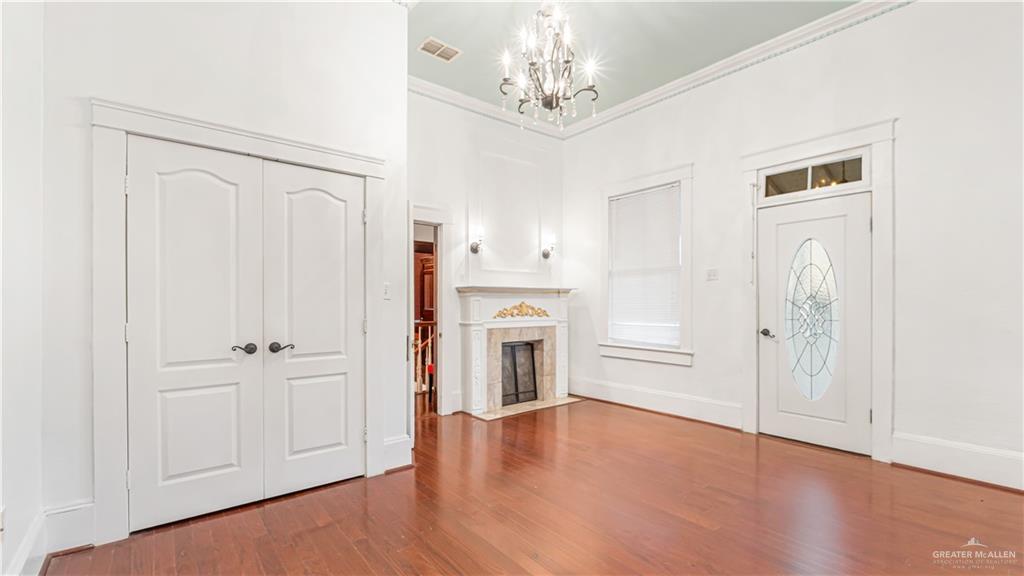 600 East Mirasoles Street Rio Grande City, TX 78582 - Photo 17 of 26 a view of a livingroom with a fireplace a ceiling fan and wooden floor