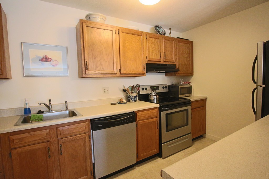 46 Evergreen Road, Unit 209 Northampton, MA 01053 - Photo 6 of 12 a kitchen with stainless steel appliances granite countertop a sink and a stove