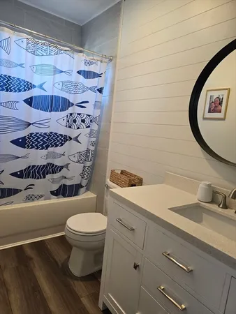 a bathroom with a sink a toilet and a mirror