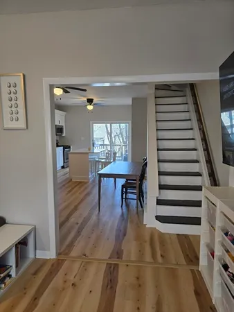 a dining room with furniture and wooden floor