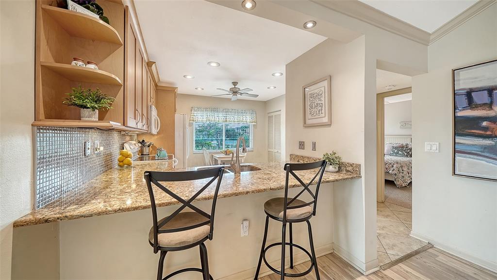 6204 Midnight Pass Road, Unit 205 Sarasota, FL 34242 - Photo 16 of 62 a view of a dining room with furniture and a window