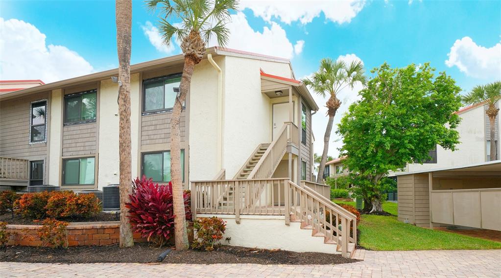 6204 Midnight Pass Road, Unit 205 Sarasota, FL 34242 - Photo 2 of 62 a view of a house with a small yard and a floor to ceiling window