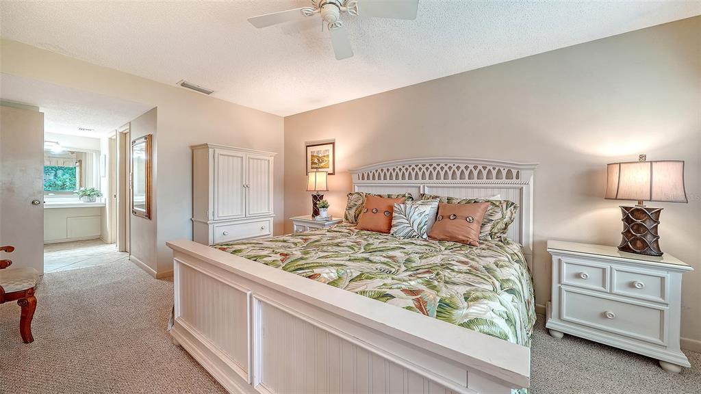6204 Midnight Pass Road, Unit 205 Sarasota, FL 34242 - Photo 24 of 62 a bedroom with a bed and a dresser in it