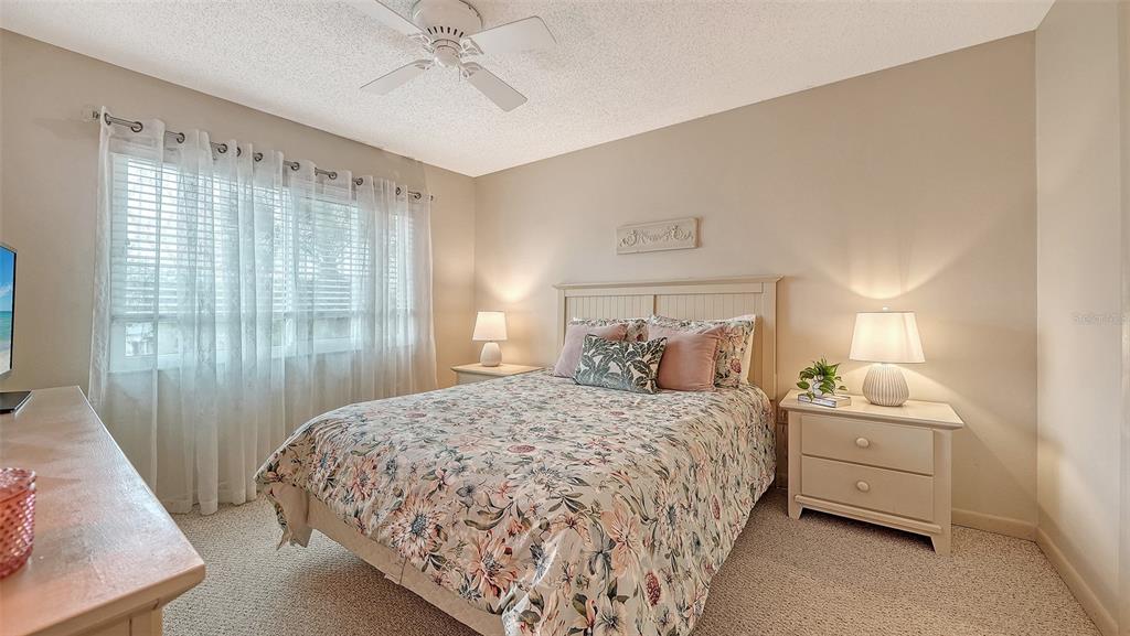 6204 Midnight Pass Road, Unit 205 Sarasota, FL 34242 - Photo 27 of 62 a bedroom with a bed and a window