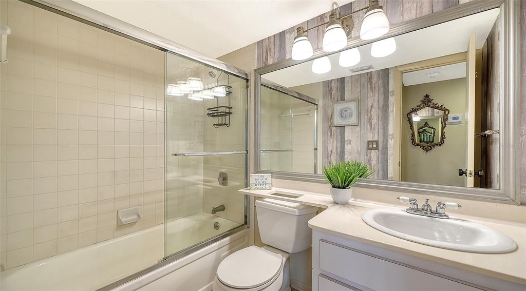 6204 Midnight Pass Road, Unit 205 Sarasota, FL 34242 - Photo 29 of 62 a bathroom with a sink toilet and shower