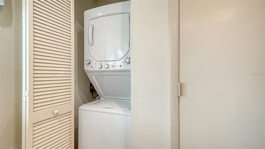6204 Midnight Pass Road, Unit 205 Sarasota, FL 34242 - Photo 30 of 62 a utility room with dryer and washer