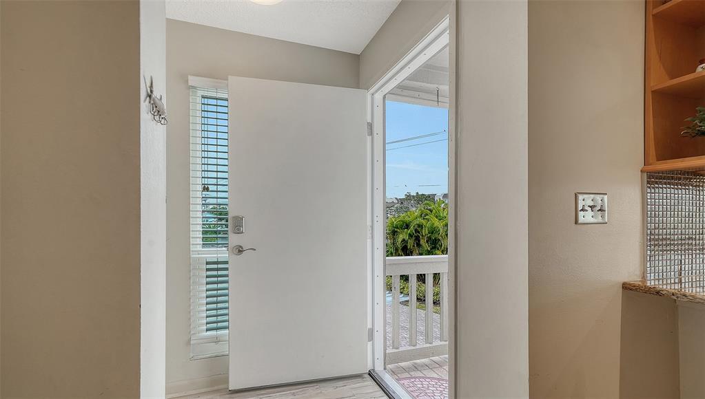6204 Midnight Pass Road, Unit 205 Sarasota, FL 34242 - Photo 3 of 62 a view of a bedroom with wooden floor