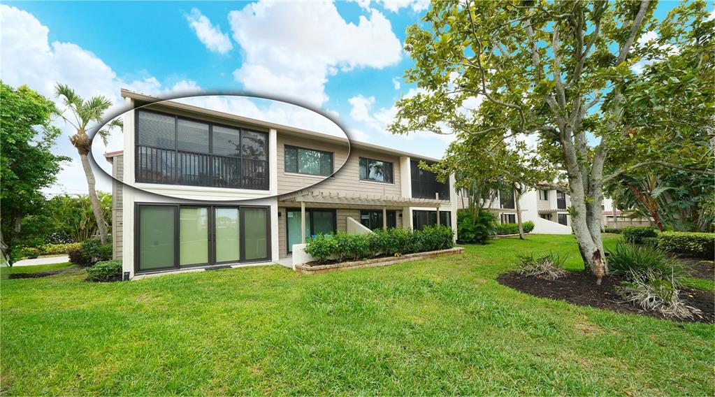 6204 Midnight Pass Road, Unit 205 Sarasota, FL 34242 - Photo 32 of 62 a front view of a house with garden