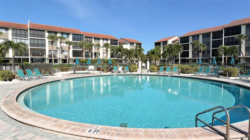 6204 Midnight Pass Road, Unit 205 Sarasota, FL 34242 - Photo 35 of 62 a view of a swimming pool with a patio