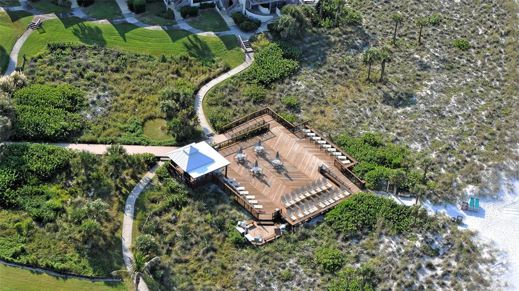 6204 Midnight Pass Road, Unit 205 Sarasota, FL 34242 - Photo 49 of 62 an aerial view of a house with a yard and trees