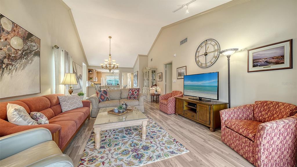 6204 Midnight Pass Road, Unit 205 Sarasota, FL 34242 - Photo 10 of 62 a living room with furniture a flat screen tv and a fireplace