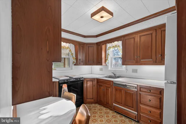 a kitchen that has a sink and a stove in it