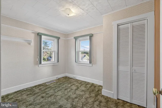 an empty room with closet area