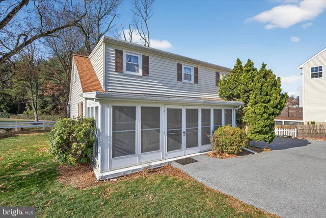 an aerial view of a house with garden space and street view