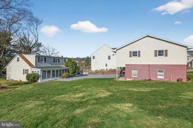 an aerial view of multiple houses with yard