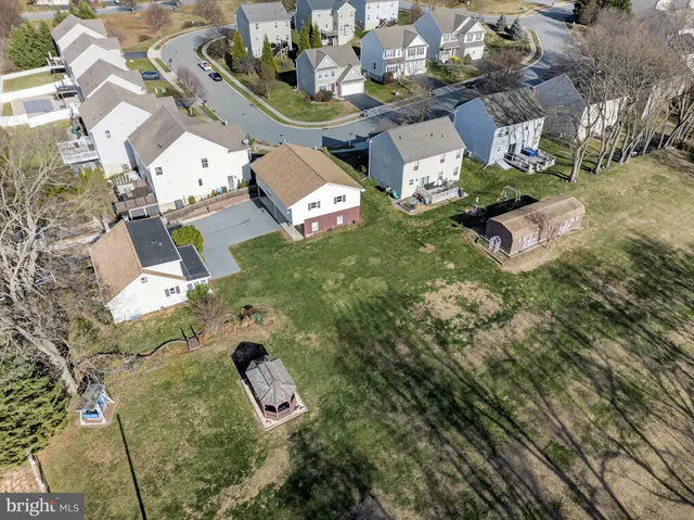 an aerial view of a residential houses with outdoor space