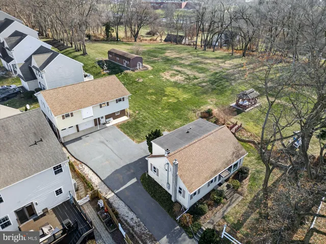 an aerial view of a house with garden space and street view
