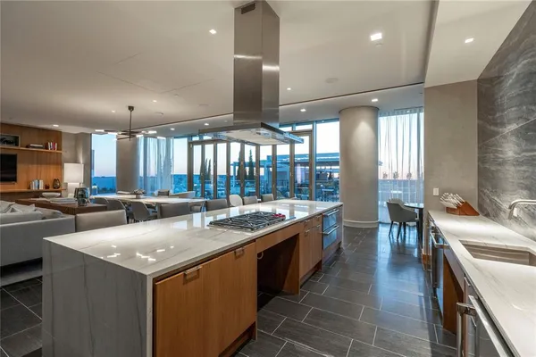 a large kitchen with a large counter top appliances and furniture